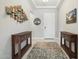 Foyer featuring console tables, stylish decor, and a patterned rug on tile flooring at 15663 S 183Rd Dr, Goodyear, AZ 85338