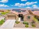 An aerial front exterior featuring desert landscaping, a two-car garage, and solar panels at 15663 S 183Rd Dr, Goodyear, AZ 85338