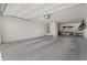 Spacious garage with white walls, concrete floor, overhead lighting and storage at 15663 S 183Rd Dr, Goodyear, AZ 85338