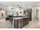 Kitchen island with granite countertops, stainless steel dishwasher, pendant lighting and adjoins living room at 15663 S 183Rd Dr, Goodyear, AZ 85338