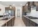 Modern kitchen featuring stainless steel appliances, granite countertops, and a stylish subway tile backsplash at 15663 S 183Rd Dr, Goodyear, AZ 85338