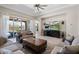 Open-concept living room with comfortable sofas, tile flooring, and a view of the backyard at 15663 S 183Rd Dr, Goodyear, AZ 85338