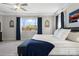 Comfortable main bedroom featuring a king bed, tray ceilings, and a view from a large window at 15663 S 183Rd Dr, Goodyear, AZ 85338