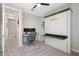 This office bedroom features a murphy bed with a small work surface, window, and desk at 15663 S 183Rd Dr, Goodyear, AZ 85338