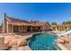 Backyard with a pool, rock landscaping, mature trees and a covered patio with an awning at 15825 N 45Th St, Phoenix, AZ 85032