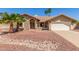 Charming single-story home boasting desert landscaping, a tile roof and mature palm trees under a bright blue sky at 15825 N 45Th St, Phoenix, AZ 85032