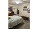 Bedroom with decorative dresser, shelving with photos, ceiling fan, and unique decor at 17823 N 99Th Dr, Sun City, AZ 85373
