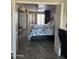 Comfortable bedroom with tiled floors, ceiling fan, and ample closet space, providing a relaxing retreat at 17823 N 99Th Dr, Sun City, AZ 85373