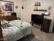Cozy bedroom featuring stylish decor, tiled floor, and decorative shelving above the entertainment center at 17823 N 99Th Dr, Sun City, AZ 85373