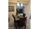 Inviting dining area with a contemporary light fixture and room with decorative sunflowers centerpiece on the table at 17823 N 99Th Dr, Sun City, AZ 85373