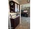 Open concept kitchen features dark cabinets and leads into a cozy living area with a ceiling fan at 17823 N 99Th Dr, Sun City, AZ 85373