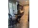 Inviting kitchen area with dark cabinets, modern tile floor, and a round table with seating near window at 17823 N 99Th Dr, Sun City, AZ 85373