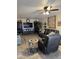 Comfortable living room featuring a ceiling fan, modern furniture, and television for entertaining guests at 17823 N 99Th Dr, Sun City, AZ 85373