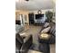 Spacious living room featuring comfortable seating, stylish decor, and large television for entertainment at 17823 N 99Th Dr, Sun City, AZ 85373