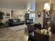 Comfortable living room featuring a plush leather sofa, ceiling fan, and decorative wall art at 17823 N 99Th Dr, Sun City, AZ 85373