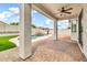 Inviting covered patio featuring brick pavers, ceiling fan, and a view of the sparkling pool and well-maintained backyard at 18286 La Posada Ct, Gold Canyon, AZ 85118