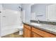 Bathroom featuring a shower-tub combo, granite countertop vanity, and neutral walls at 18286 La Posada Ct, Gold Canyon, AZ 85118