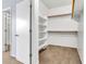 Spacious walk-in closet with built-in shelving and rods for ample storage at 18286 La Posada Ct, Gold Canyon, AZ 85118