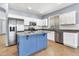Bright kitchen boasts stainless appliances, granite counters, a center island, and white cabinets at 18286 La Posada Ct, Gold Canyon, AZ 85118