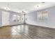Open-concept living room with tile and wood flooring, large windows, and bright natural light at 18286 La Posada Ct, Gold Canyon, AZ 85118