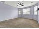 Large primary bedroom with carpet flooring and multiple windows offers natural lighting and outdoor views at 18286 La Posada Ct, Gold Canyon, AZ 85118