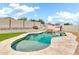 Sparkling pool featuring a rock waterfall feature in a private backyard oasis at 18286 La Posada Ct, Gold Canyon, AZ 85118
