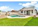 Inviting backyard pool with well-manicured lawn and desert landscaping at 18286 La Posada Ct, Gold Canyon, AZ 85118