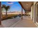 Expansive backyard featuring a covered patio, outdoor kitchen, and inviting pool with rock features at 18401 N 14Th St, Phoenix, AZ 85022