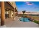 Beautiful backyard with a covered patio, mountain views, and a freeform pool with rock features at 18401 N 14Th St, Phoenix, AZ 85022