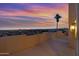 Balcony at sunset with city view, palm trees, and a desert landscape at 18401 N 14Th St, Phoenix, AZ 85022
