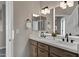 Bathroom featuring double sinks, light fixtures, and a large mirror at 18401 N 14Th St, Phoenix, AZ 85022