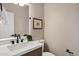 Elegant half-bathroom featuring a modern sink and marble countertop at 18401 N 14Th St, Phoenix, AZ 85022
