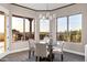 Bright breakfast nook with a glass table and stunning views from multiple windows at 18401 N 14Th St, Phoenix, AZ 85022