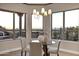 Elegant dining area with a glass table, comfortable chairs, and picturesque views from many windows at 18401 N 14Th St, Phoenix, AZ 85022