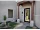 Close up of front entrance with desert landscaping, decorative rock, and a wood portico at 18401 N 14Th St, Phoenix, AZ 85022