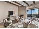 Inviting living room features beamed ceilings, modern fireplace, and sliding doors with stunning views at 18401 N 14Th St, Phoenix, AZ 85022