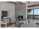 Comfortable living room features a modern fireplace, sleek wood beams, and expansive views at 18401 N 14Th St, Phoenix, AZ 85022