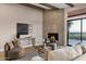 Stylish living room showcasing a stone fireplace, comfortable seating, and access to an outdoor patio at 18401 N 14Th St, Phoenix, AZ 85022