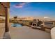 Outdoor entertaining area with a beautiful pool, grill and fireplace overlooking the sunset view at 18401 N 14Th St, Phoenix, AZ 85022