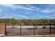View of the desert landscape beyond the secure wrought iron fencing, providing an unobstructed view from the property at 20210 N Wagner Wash Dr, Buckeye, AZ 85396
