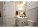 Stylish bathroom featuring a white vanity, dark hardware, and a modern toilet at 20210 N Wagner Wash Dr, Buckeye, AZ 85396