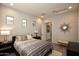 Inviting bedroom with tiled floors, neutral paint, recessed lighting, windows, and stylish furniture at 20210 N Wagner Wash Dr, Buckeye, AZ 85396