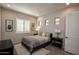 Cozy bedroom with a plush bed, wood-look tile flooring, and plantation shutters at 20210 N Wagner Wash Dr, Buckeye, AZ 85396