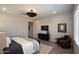 This bedroom includes wood tile flooring, recessed lighting, a large bed, and a tv with a console at 20210 N Wagner Wash Dr, Buckeye, AZ 85396