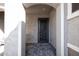Covered entryway featuring stylish pavers and a decorative security door, providing a welcoming and secure entrance at 20210 N Wagner Wash Dr, Buckeye, AZ 85396