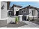 Lovely gated courtyard with textured stucco, beautiful landscaping, and stone accents, creating a welcoming entrance at 20210 N Wagner Wash Dr, Buckeye, AZ 85396