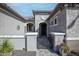 Gated entry to a charming courtyard featuring lovely landscaping and comfortable outdoor seating at 20210 N Wagner Wash Dr, Buckeye, AZ 85396