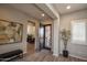 Inviting foyer with decorative front door, art, wood-look tile flooring, and access to living space at 20210 N Wagner Wash Dr, Buckeye, AZ 85396