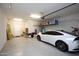 A spacious garage with epoxy flooring and overhead storage, perfect for vehicles and organization at 20210 N Wagner Wash Dr, Buckeye, AZ 85396