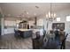 Open-concept kitchen and dining area featuring a modern chandelier and a large kitchen island at 20210 N Wagner Wash Dr, Buckeye, AZ 85396